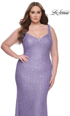A woman wears the La Femme Long Prom Dress 31163, a fitted sparkly lavender gown with wide straps, standing before a white background. The La Femme logo is visible in the upper right corner.