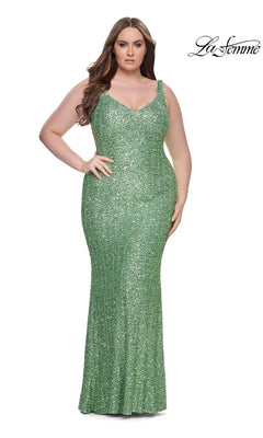 A woman models the La Femme Long Prom Dress 31163—a fitted, sleeveless green gown—against a white background with the "La Femme" logo in the top right corner.