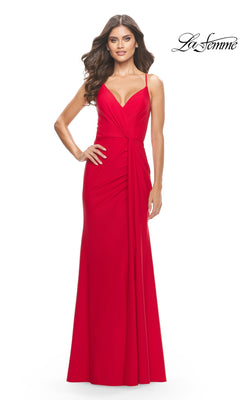 A woman in a sleeveless, floor-length red Twist-Front La Femme Long Formal Dress 31169 with spaghetti straps and an open back stands against a white background. The "La Femme" logo is displayed in the top right corner.