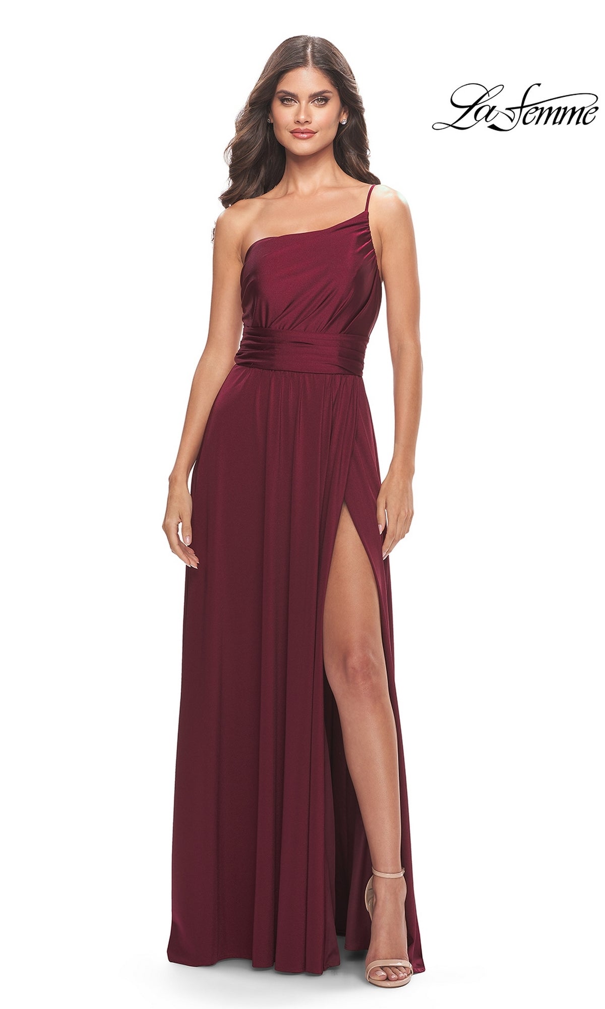 A woman stands against a white background wearing the One-Shoulder Long La Femme Formal Dress 31170, a sleeveless burgundy gown with a high slit. The La Femme logo is displayed in the top right corner.