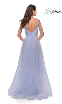 A woman stands facing away in the La Femme A-Line Long Tulle Prom Dress 31204, a floor-length light purple gown with thin straps, low back, and flowing layers of ethereal tulle.
