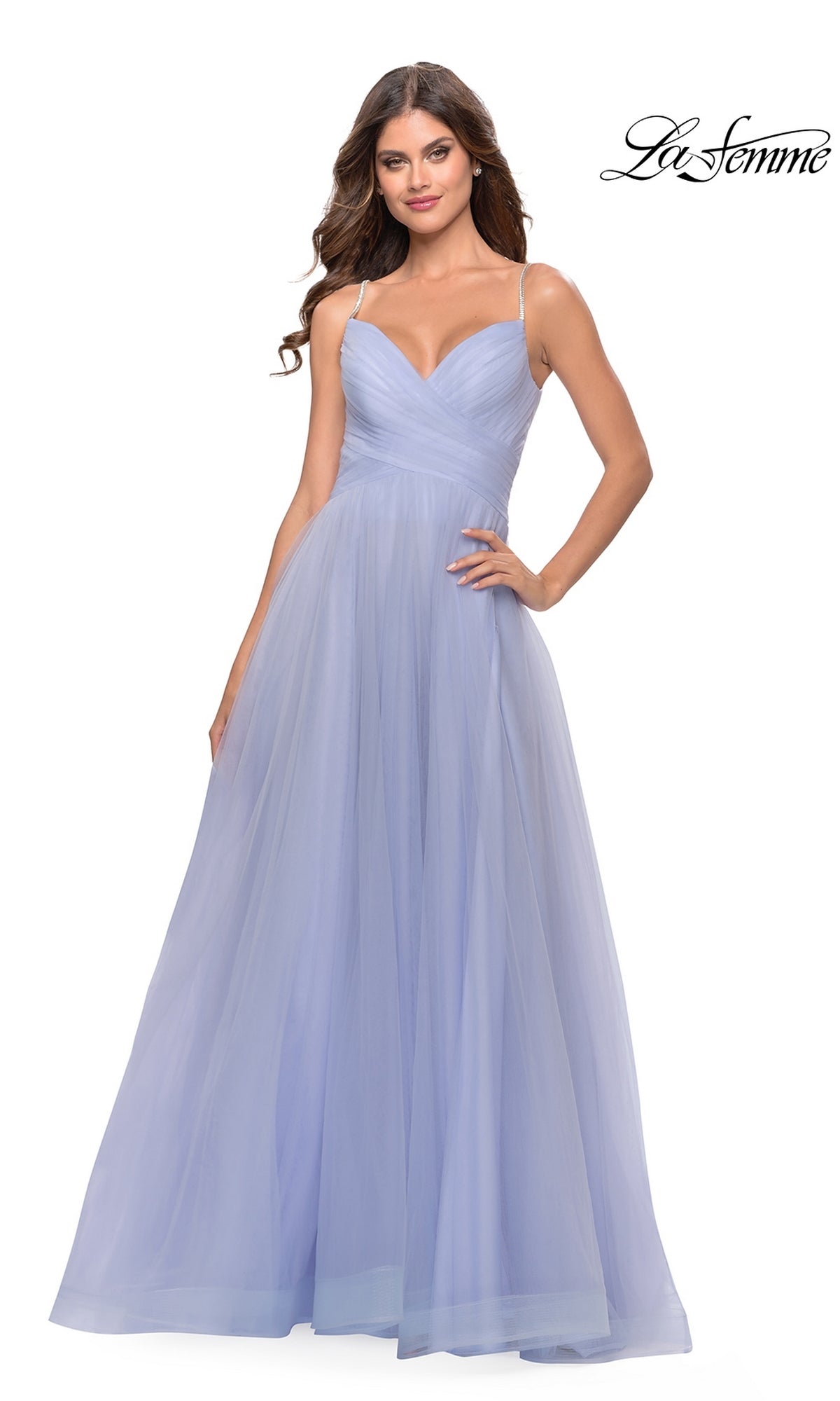Woman models the La Femme A-Line Long Tulle Prom Dress 31204 in light purple, featuring spaghetti straps, a fitted bodice, and a flowing full-length skirt on a white background.