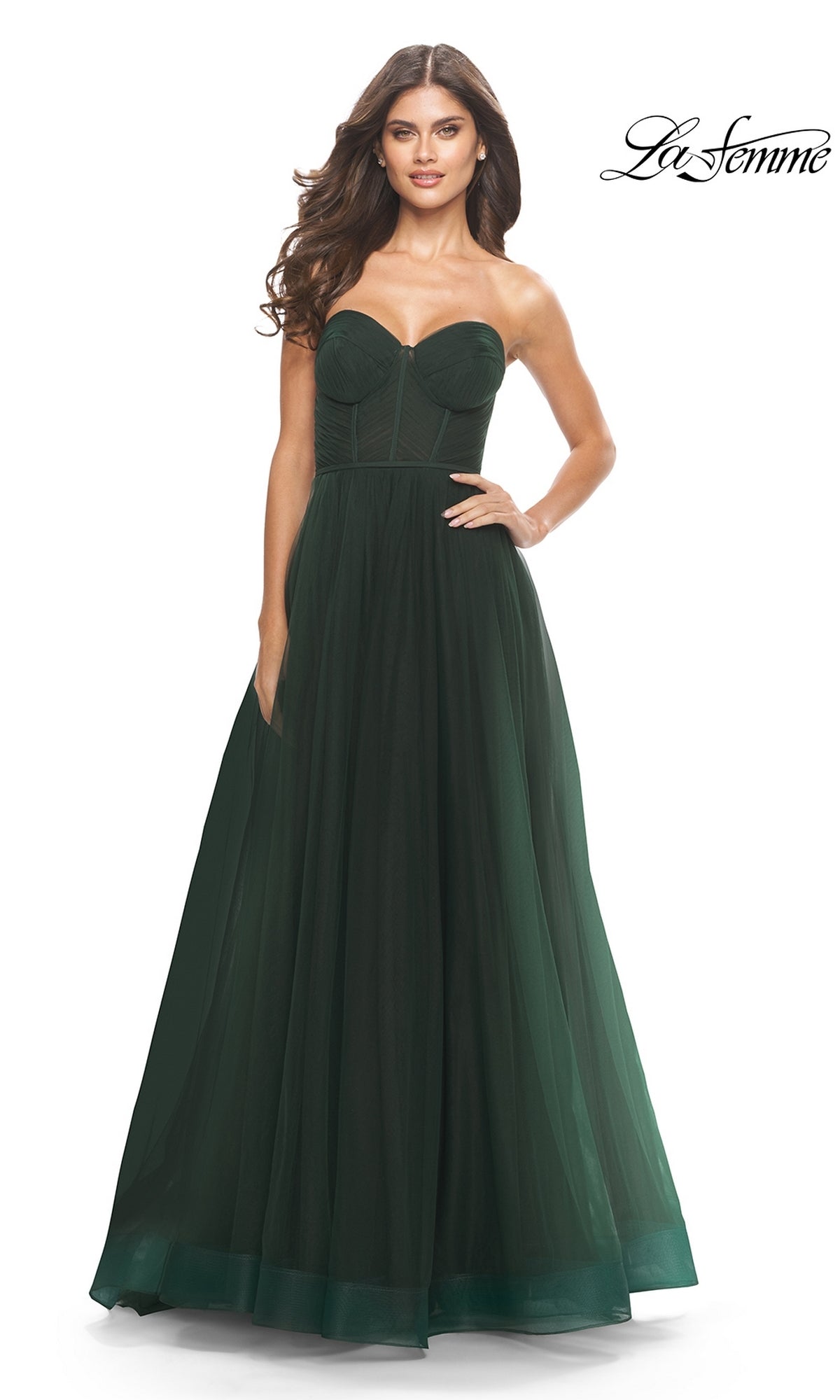 A woman models the Strapless Long Prom Ball Gown: La Femme 31205, featuring a fitted bodice and full A-line skirt, against a white background with 