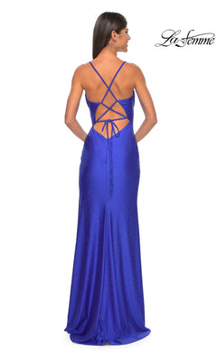 A woman wears the La Femme Shimmer Jersey Cowl-Neck Prom Dress 31221, a floor-length royal blue gown with a fitted silhouette, cowl neckline, crisscross lace-up open back, and subtle shimmer for a stunning prom look.