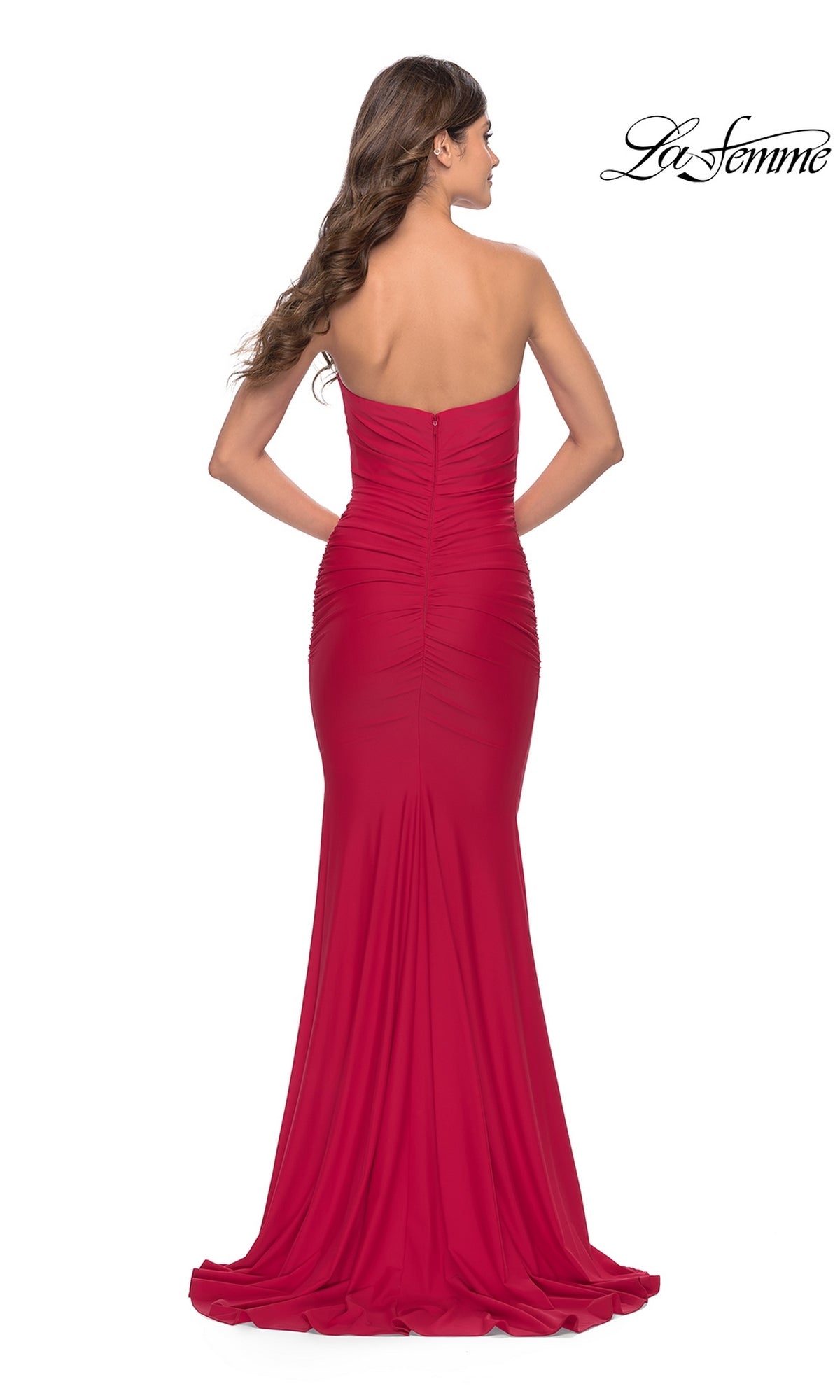 A woman stands with her back to the camera wearing the La Femme Classic Strapless Tight Prom Dress 31226, a floor-length red gown with ruched detailing.