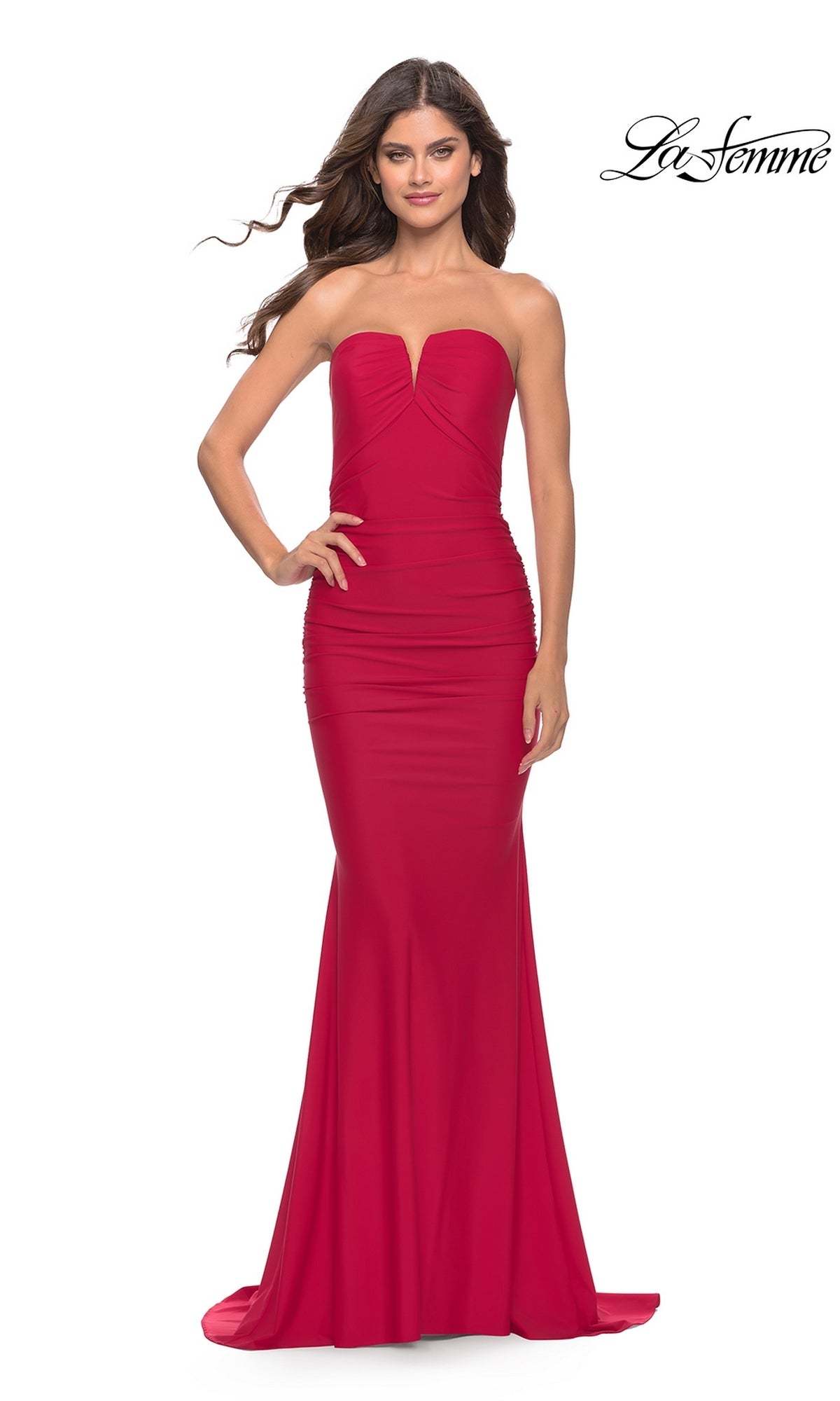 A woman models the La Femme Classic Strapless Tight Prom Dress 31226—fitted, floor-length, and red with a slight sweetheart neckline—against a white background.