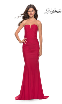 A woman models the La Femme Classic Strapless Tight Prom Dress 31226—fitted, floor-length, and red with a slight sweetheart neckline—against a white background.