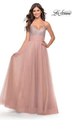 A woman smiles in the Beaded-Bodice Tulle Prom Ball Gown 31238, featuring a blush pink hue, beaded bodice, and tulle skirt. The La Femme logo is displayed in the top right corner.