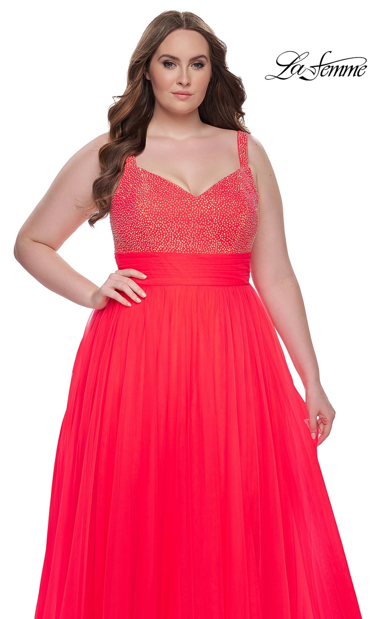 A woman models the La Femme Long Prom Dress 31251, a vibrant red plus-size gown with a sparkling beaded bodice and flowing skirt, against a white background. The 