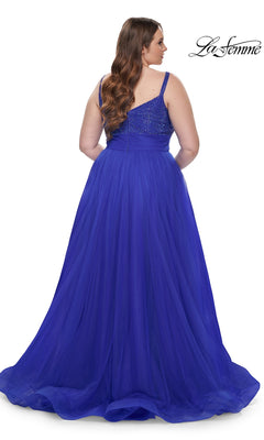 A woman is seen from behind in the La Femme Long Prom Dress 31251, a floor-length, sleeveless royal blue gown with a fitted beaded bodice, set against a white background.