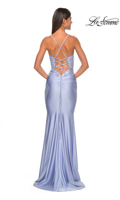 A woman showcases the fitted silhouette and elegant long train of the La Femme Sheer-Corset Tight Long Prom Dress 31272, in lavender satin with an embroidered lace bodice, lace-up open back, and crisscross straps.
