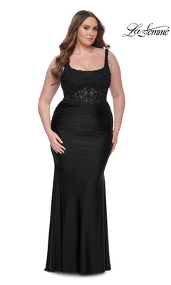 A woman models the La Femme Long Prom Dress 31273, featuring a black lace bodice and fitted skirt, against a plain white background. The "La Femme" logo appears in the top right corner.