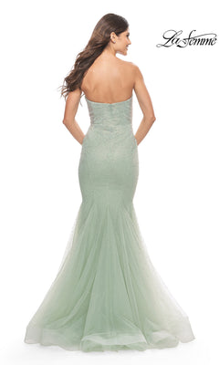 Back view of the light green strapless mermaid La Femme 31285 prom dress, covered in shimmering embellishments with a flared tulle hem.