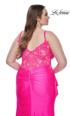 A woman with long brown hair is seen from behind wearing the La Femme Long Prom Dress 31309, a sparkly bright pink gown with beaded lace details and a low back. The La Femme logo appears in the top right corner.