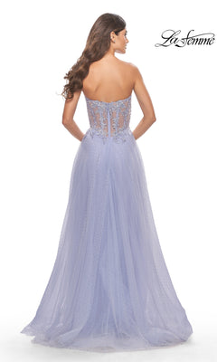 A woman is shown from behind in the La Femme Strapless Sheer-Waist Prom Dress 31367, featuring delicate lace embroidery, a sheer embellished back, and a flowing A-line tulle skirt.