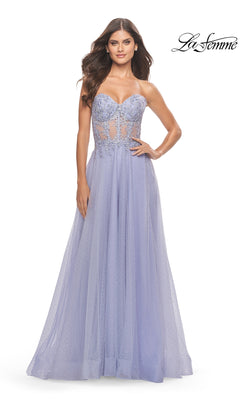 A woman poses against a white background in the La Femme Strapless Sheer-Waist Prom Dress 31367, featuring a lavender hue, beaded bodice, sheer waist detail, and an elegant A-line tulle skirt. The La Femme logo is in the top right corner.