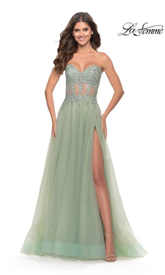 A woman models the La Femme Strapless Sheer-Waist Prom Dress 31367 in light green, featuring a beaded sheer bodice, lace embroidery, an A-line tulle skirt with high slit, against a white background.
