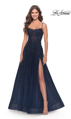 A woman models the La Femme Lace-Bodice Long A-Line Prom Dress 31381—navy blue with spaghetti straps, floral embellishments, embroidered lace bodice, and high slit—against a white background with the "La Femme" logo in the top right.
