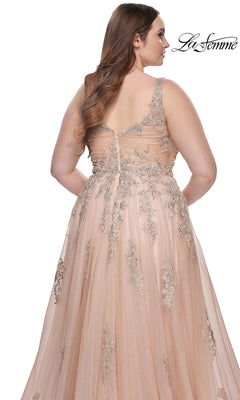 A woman shown from the back wears the La Femme Long Prom Dress 31383, a blush sleeveless formal gown with floral embroidery on a sheer overlay, a zipper closure, embroidered lace details, and a flowing skirt.