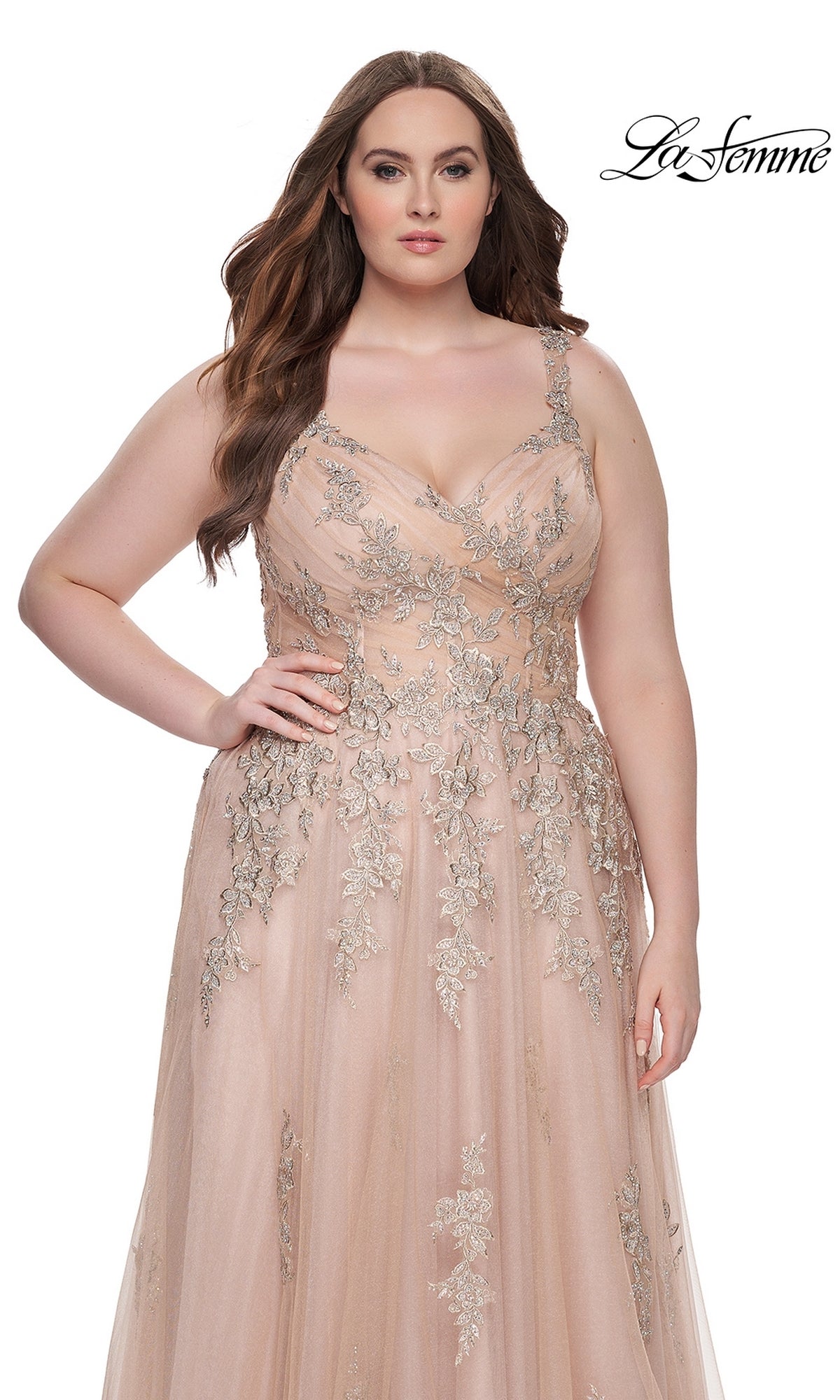 A woman models the La Femme Long Prom Dress 31383, a sleeveless blush embroidered lace gown with silver floral details, standing against a white background. The La Femme logo is in the top right corner.