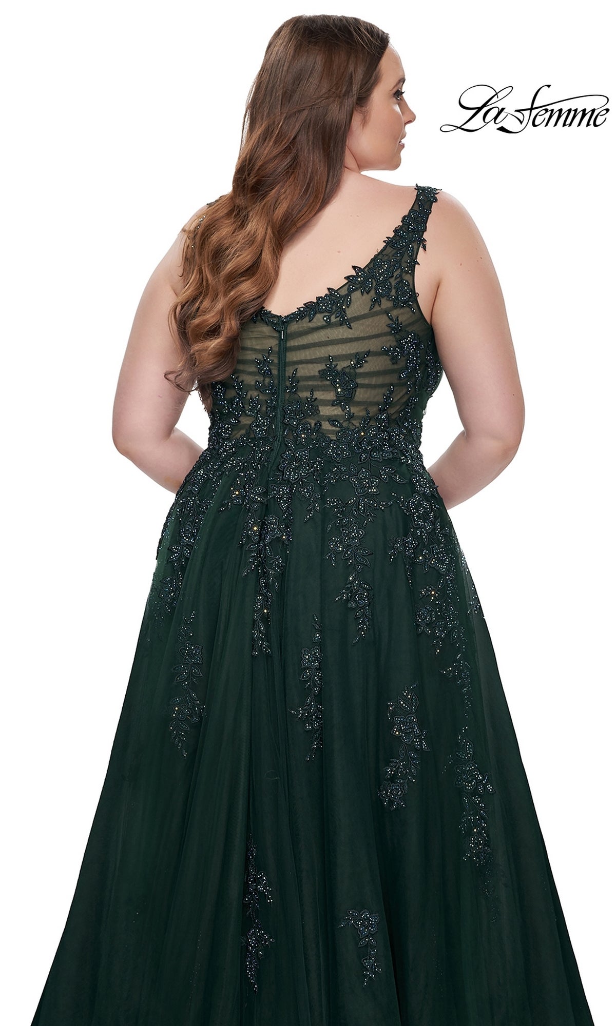 A woman with long wavy hair is shown from the back wearing the La Femme Long Prom Dress 31383, a dark green sleeveless embroidered lace gown with beaded detailing. The La Femme logo appears in the top right corner.