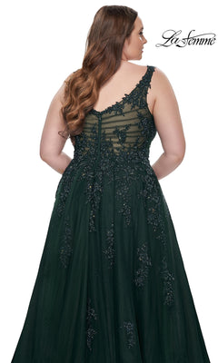 A woman with long wavy hair is shown from the back wearing the La Femme Long Prom Dress 31383, a dark green sleeveless embroidered lace gown with beaded detailing. The La Femme logo appears in the top right corner.