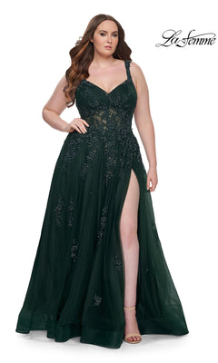 A woman wearing the La Femme Long Prom Dress 31383, a dark green sleeveless formal gown with floral embellishments and a thigh-high slit, stands against a white background. The La Femme logo appears in the top right corner.