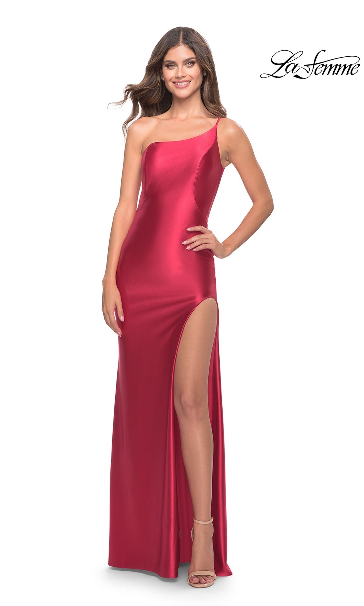 A woman wears the Long Prom Dress: La Femme 31391, a floor-length red liquid jersey one-shoulder gown with a high side slit and strappy heels.