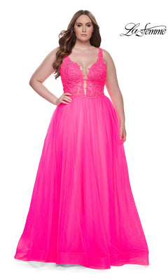 A woman models the La Femme Long Prom Dress 31394—a bright pink, sleeveless, floor-length gown with an embroidered lace bodice and tulle skirt—against a white background. The La Femme logo appears in the top right corner.