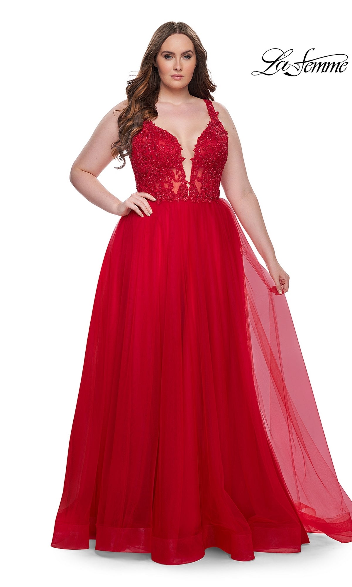 A woman wearing the La Femme Long Prom Dress 31394, featuring a sleeveless embroidered lace bodice and tulle floor-length skirt, stands against a white background.