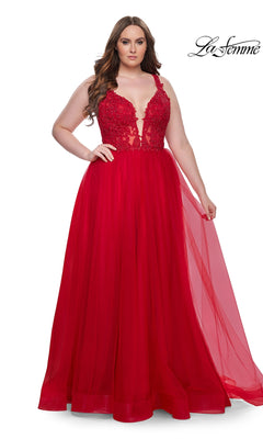 A woman wearing the La Femme Long Prom Dress 31394, featuring a sleeveless embroidered lace bodice and tulle floor-length skirt, stands against a white background.