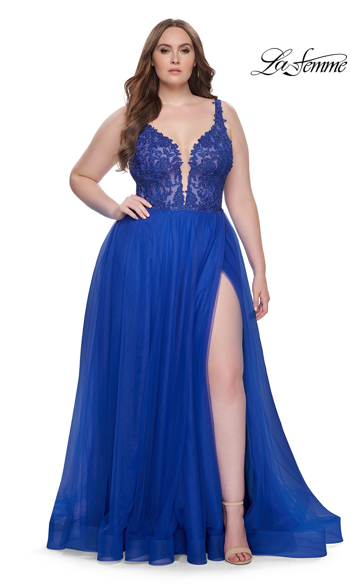 A woman wears the La Femme Long Prom Dress 31394, a royal blue sleeveless gown with an embroidered lace bodice, deep V neckline, and thigh-high slit. She stands against a white background with the 