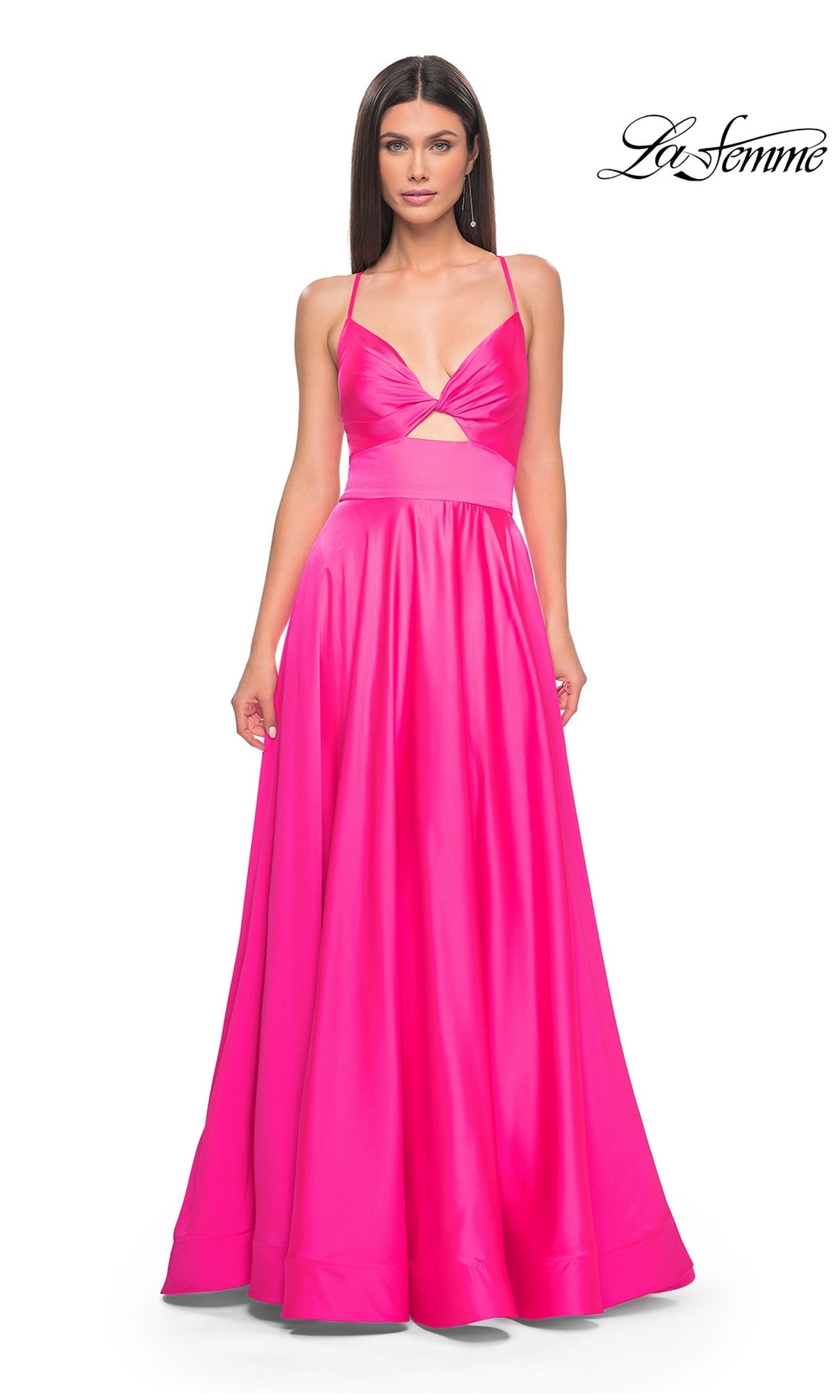 A woman wears the La Femme Twist-Front Long A-Line Prom Dress 31412 in bright pink, featuring spaghetti straps, a floor-length skirt, an open back, underbust cut-out, and wide waistband. The La Femme logo appears in the top right corner.