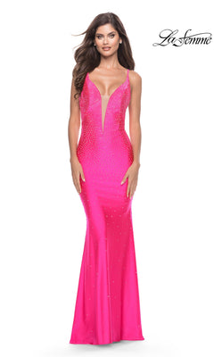 A woman wearing a neon pink, floor-length, fitted jersey Long Prom Dress: La Femme 31413 with a deep V-neckline and a sparkly, embellished bodice.