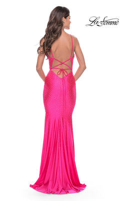 Back view of a hot pink, fitted jersey La Femme 31413 prom dress with a lace-up open back and scattered rhinestone embellishments.