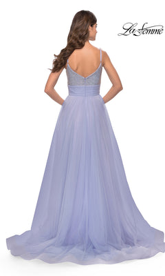 A woman with long, wavy hair models the La Femme 31433 Beaded-Bodice Long Prom Dress, featuring an embellished V-neck and flowing lavender tulle skirt, shown from the back. The La Femme logo is displayed in the top right corner.