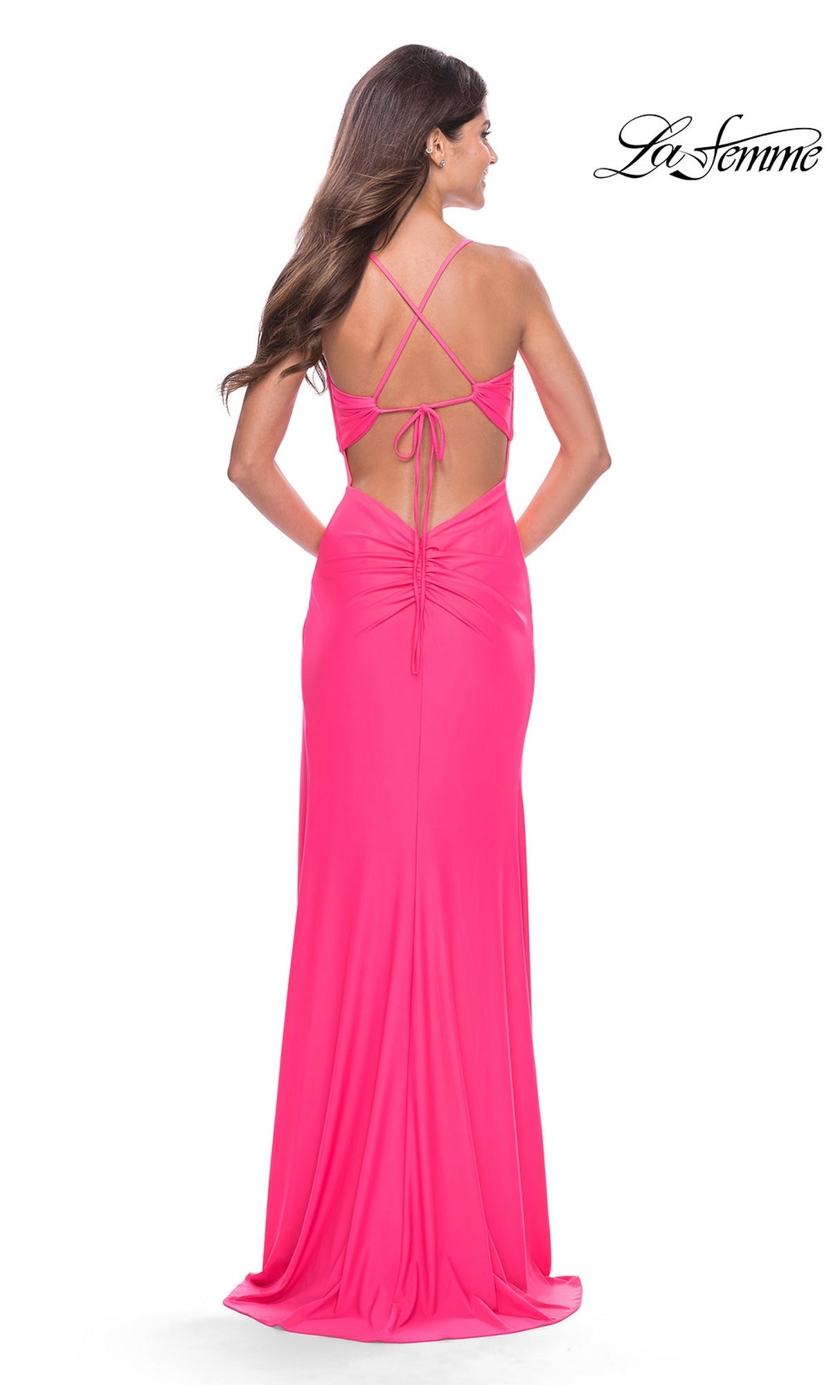Back view of the Long Prom Dress: La Femme 31446, a floor-length hot pink jersey gown with a strappy open back, twist-knot details, and ruching at the lower back.
