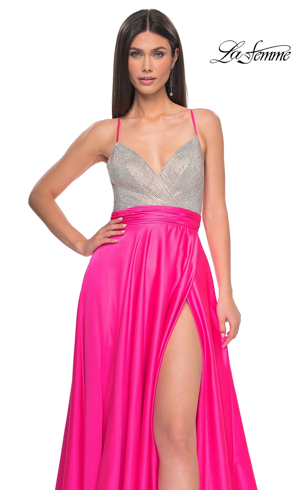 A woman models the La Femme Neon Pink Long Prom Dress 31448, featuring a silver beaded bodice with thin straps and a high slit, against a white background. The La Femme logo is displayed in the top right corner.
