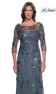La Femme 31458 is a slate gray formal dress with a floor-length A-line silhouette, three-quarter sleeves, and a sheer bodice embellished with floral beadwork and sequins.