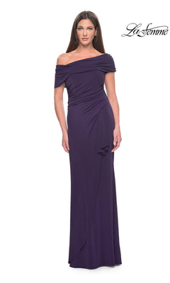 Woman wearing an eggplant La Femme 31459 floor-length evening gown featuring an off-the-shoulder neckline and ruched detailing at the waist.