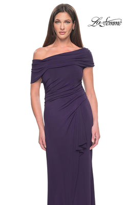 The La Femme 31459 is a dark purple, off-the-shoulder formal gown featuring a draped, ruched bodice and an asymmetrical side-slit skirt.