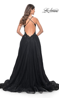 A woman stands against a white background wearing the La Femme Beaded-Bodice Long A-Line Prom Gown 31471, featuring a low back, crisscross straps, and a flowing black tulle skirt.