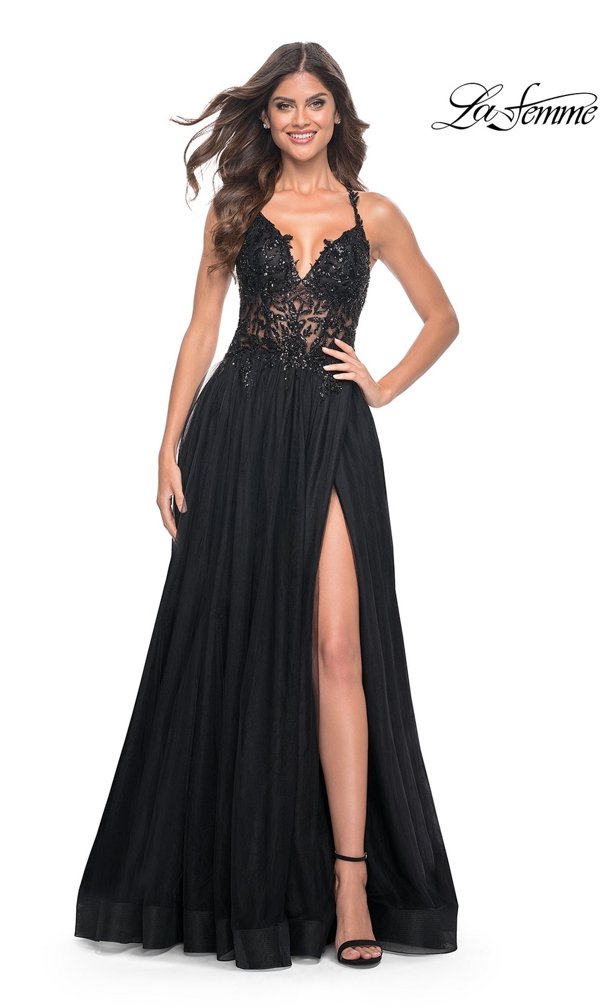 A woman smiles against a white background, wearing the La Femme Beaded-Bodice Long A-Line Prom Gown 31471, a black designer dress featuring a lace bodice, sheer details, and a high leg slit.