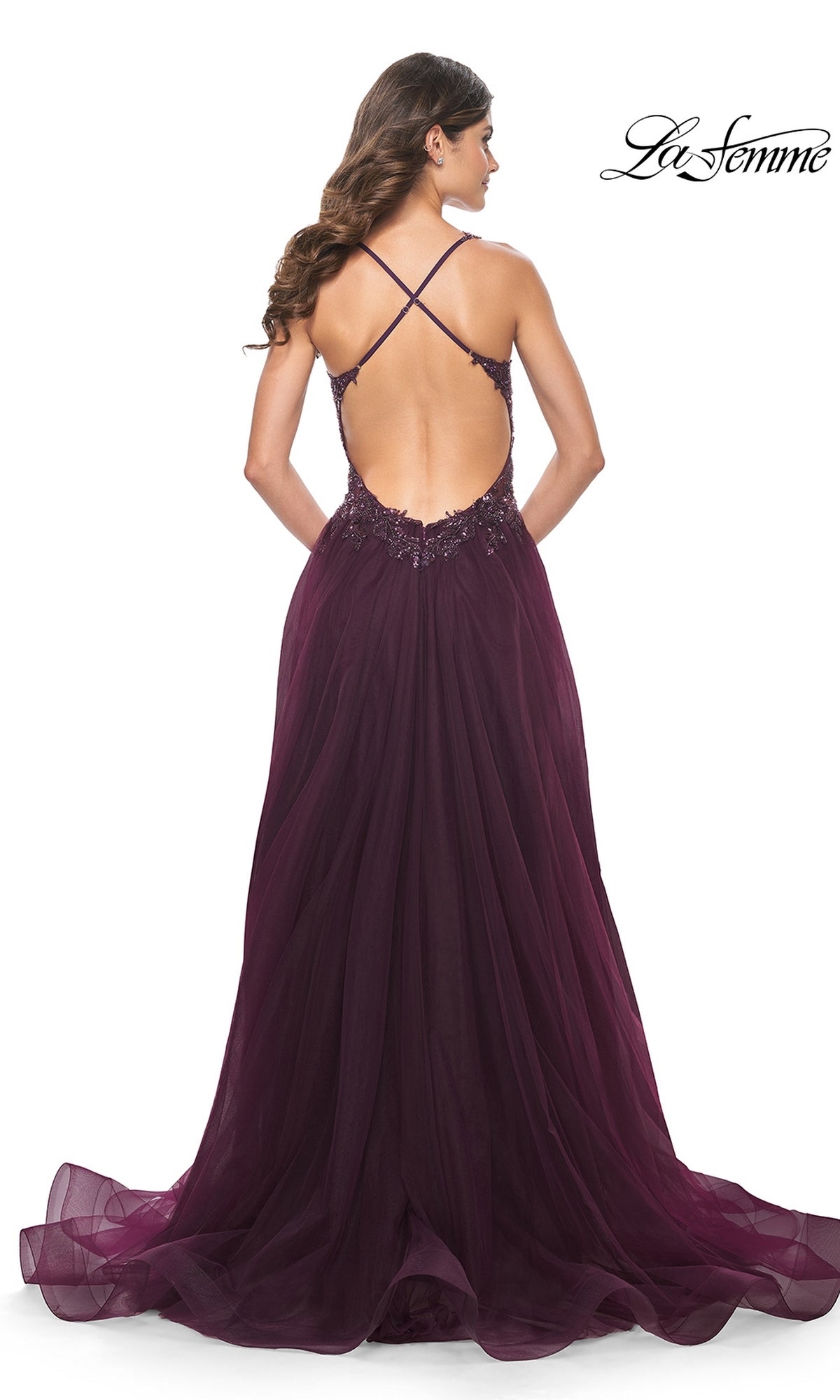 Woman wearing the La Femme Beaded-Bodice Long A-Line Prom Gown 31471, a floor-length deep purple dress with a low back, crisscross straps, and flowing tulle skirt, photographed from behind.