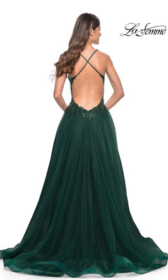 A woman is seen from behind wearing the La Femme Beaded-Bodice Long A-Line Prom Gown 31471, featuring a dark green tulle skirt, embroidered details, and an open back with crisscross straps.