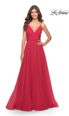 A woman smiles while wearing the La Femme V-Neck Long A-Line Prom Dress 31500, a sleeveless, floor-length red gown with spaghetti straps and a V-neckline. The La Femme logo appears in the top right corner.