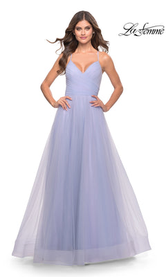 A woman wears the La Femme Wrap-Bodice Long A-Line Prom Dress 31501 in light lavender, featuring spaghetti straps, a fitted ruched bodice, and flowing ethereal tulle. The La Femme logo appears in the top right corner.