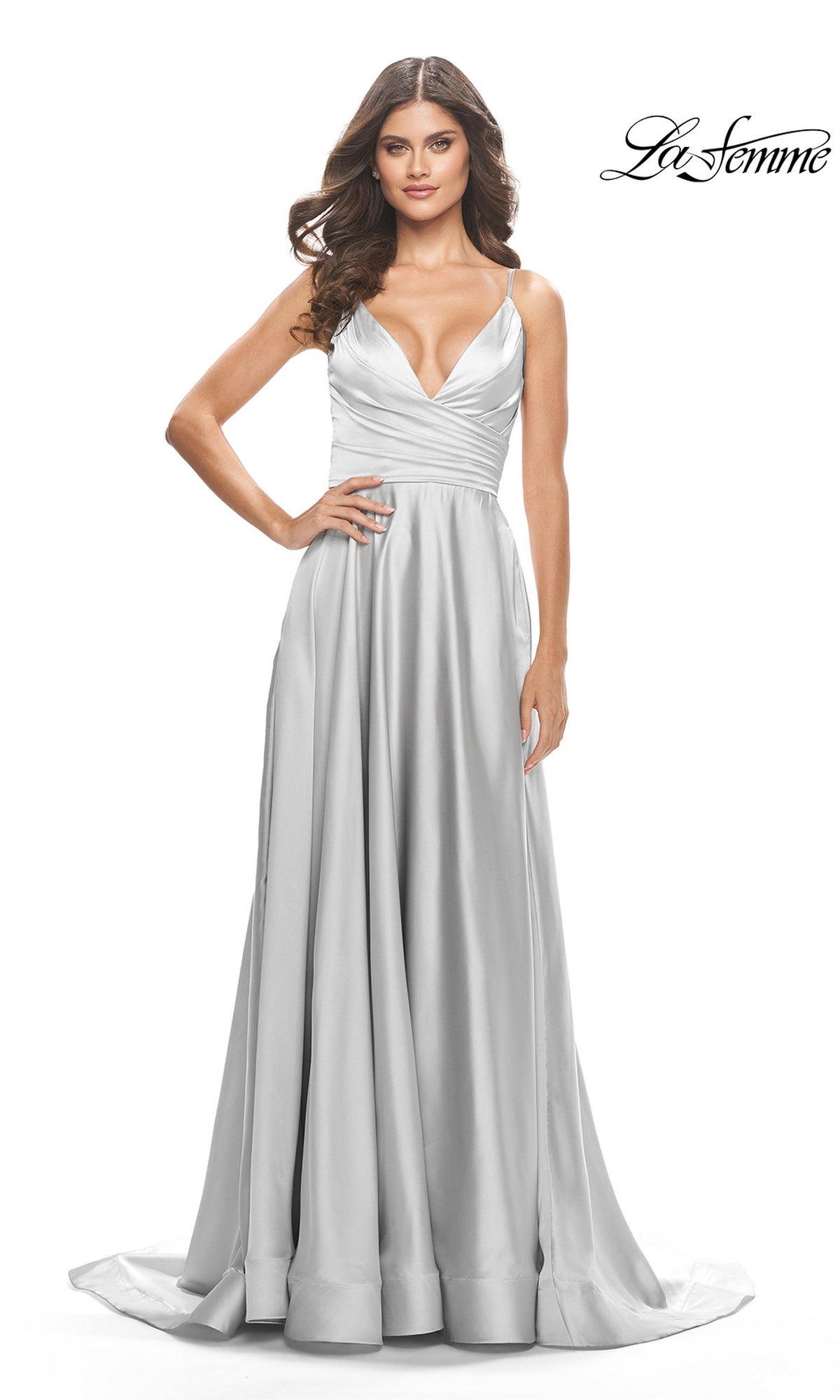 A woman wearing the La Femme V-Neck Long A-Line Prom Dress 31505, a floor-length silver satin gown with thin straps and a deep V-neckline. The fitted bodice and flowing skirt create an elegant silhouette against a plain white background.