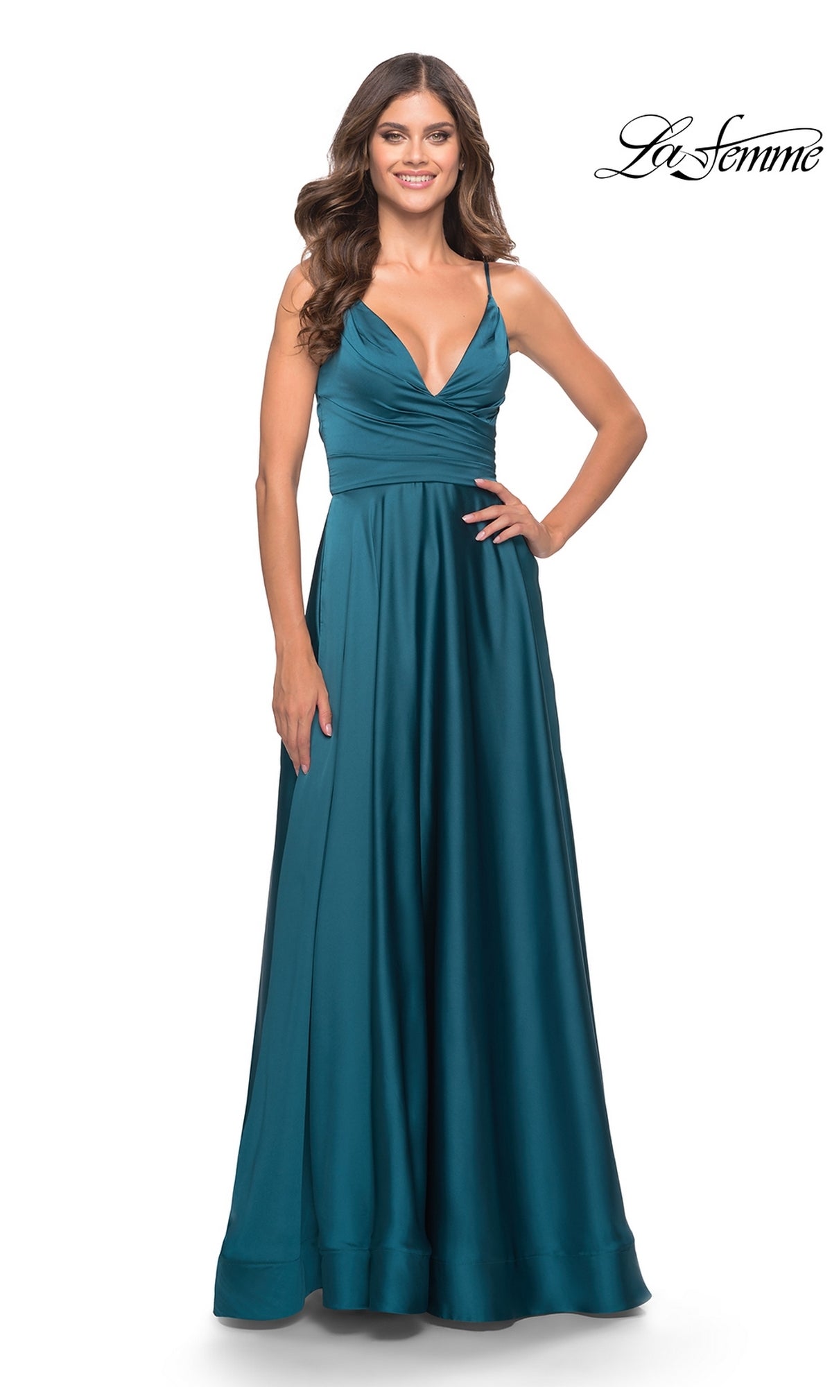 Woman in a teal satin La Femme V-Neck Long A-Line Prom Dress 31505 with fitted bodice and thin straps, standing against a plain white background.