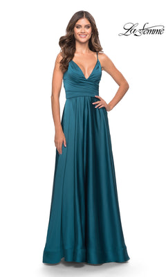 Woman in a teal satin La Femme V-Neck Long A-Line Prom Dress 31505 with fitted bodice and thin straps, standing against a plain white background.
